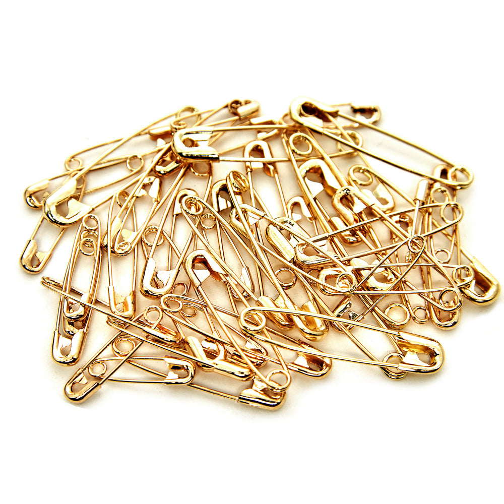 Glass tube of 50 matching dirty pins - gold